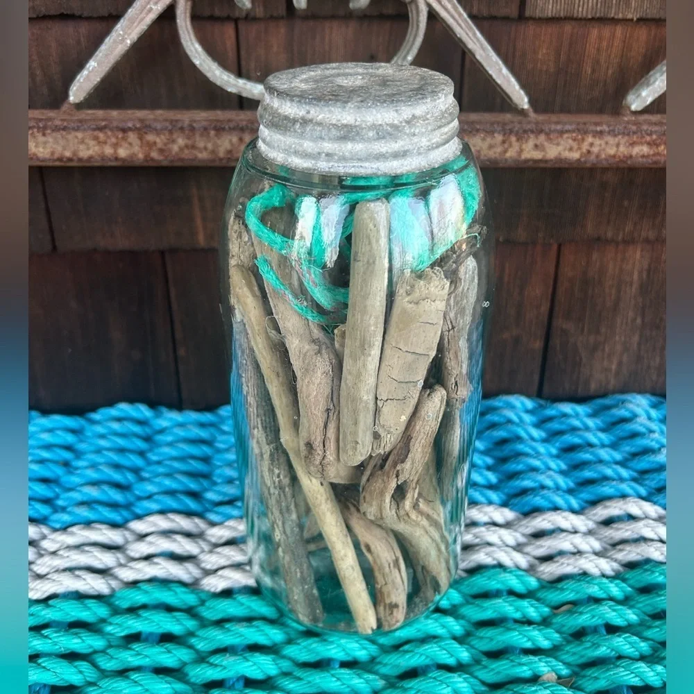 Vintage glass jar with zinc top filled with driftwood and sea rope from Montauk